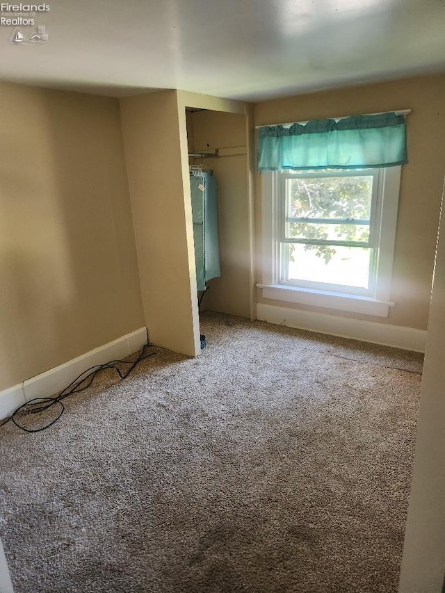 1501 E State St, Port Clinton, OH 43452 - unfurnished bedroom with carpet flooring, a closet, and baseboards