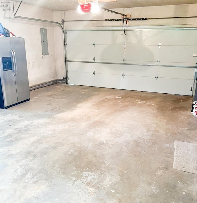 garage with stainless steel fridge, electric panel, and a garage door opener