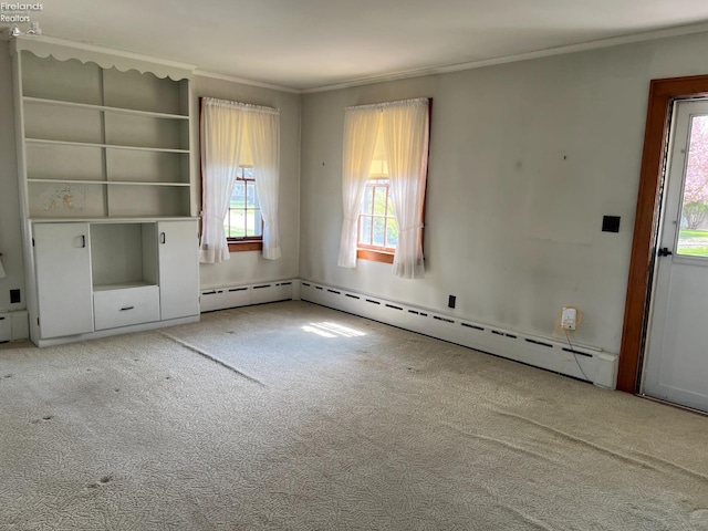 201 Gilcher Ct, Sandusky, OH 44870 - unfurnished living room featuring a baseboard heating unit, carpet floors, and ornamental molding