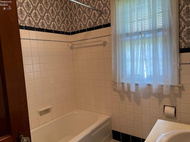201 Gilcher Ct, Sandusky, OH 44870 - full bathroom featuring tile walls, plenty of natural light, shower / bathing tub combination, and wallpapered walls