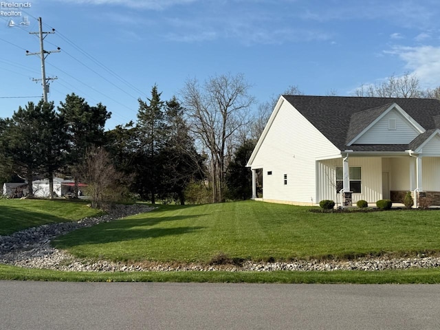 4340 E Mckenna Ln, Port Clinton, OH 43452 - view of side of property with a lawn and roof with shingles