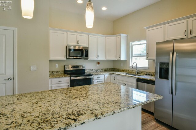 4340 E Mckenna Ln, Port Clinton, OH 43452 - kitchen featuring appliances with stainless steel finishes, a sink, white cabinets, light stone countertops, and recessed lighting