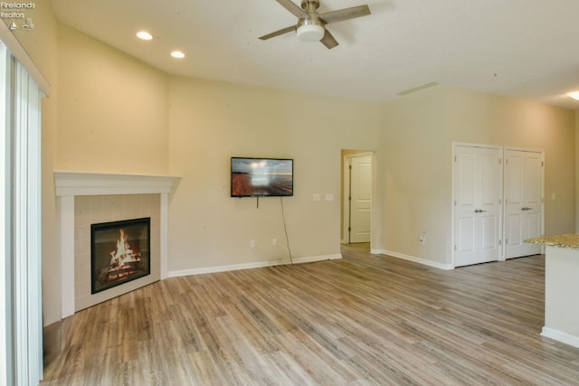 4340 E Mckenna Ln, Port Clinton, OH 43452 - unfurnished living room featuring ceiling fan, light wood-style flooring, a fireplace, recessed lighting, and baseboards