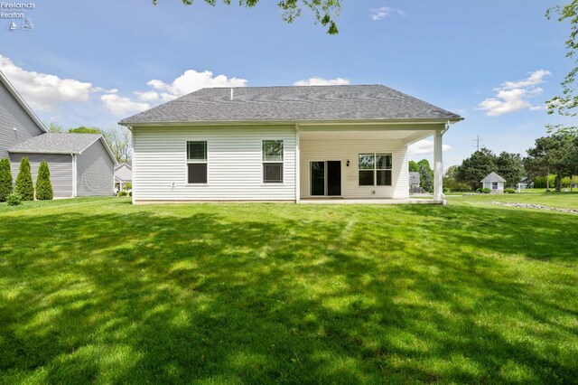 4340 E Mckenna Ln, Port Clinton, OH 43452 - rear view of property featuring a lawn and a patio area