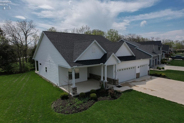4340 E Mckenna Ln, Port Clinton, OH 43452 - view of front of house featuring a porch, a front lawn, an attached garage, concrete driveway, and a shingled roof
