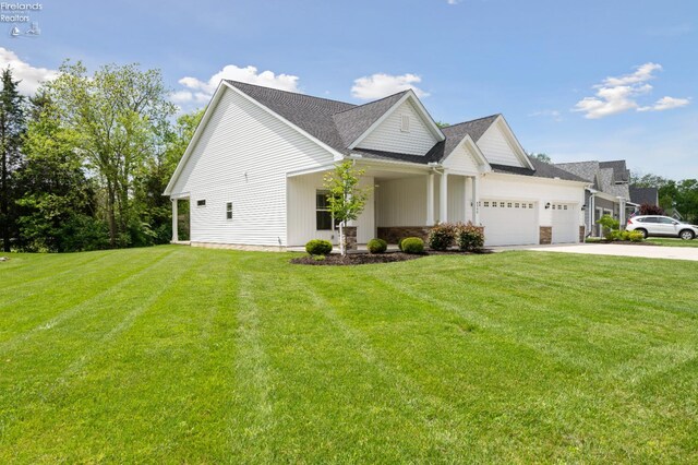 4340 E Mckenna Ln, Port Clinton, OH 43452 - view of front of property featuring a garage, driveway, and a front lawn