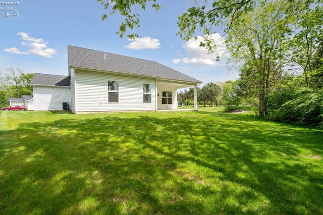 4340 E Mckenna Ln, Port Clinton, OH 43452 - back of house featuring a lawn and central AC unit