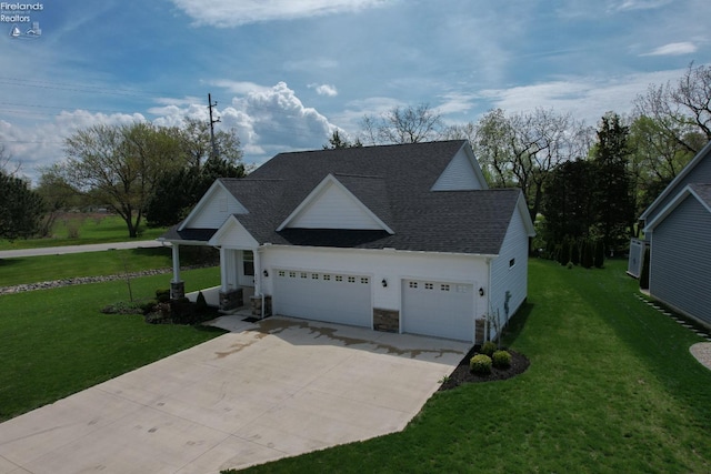 4340 E Mckenna Ln, Port Clinton, OH 43452 - view of front of house with a front yard, an attached garage, concrete driveway, and a shingled roof