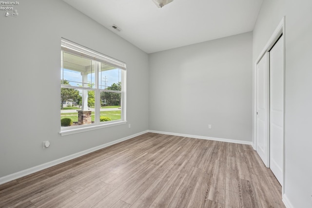 4340 E Mckenna Ln, Port Clinton, OH 43452 - unfurnished bedroom with light wood-type flooring, a closet, and baseboards