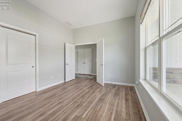4340 E Mckenna Ln, Port Clinton, OH 43452 - unfurnished bedroom featuring wood finished floors and baseboards