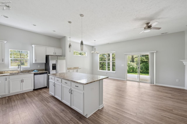4340 E Mckenna Ln, Port Clinton, OH 43452 - kitchen with dishwasher, stainless steel fridge with ice dispenser, open floor plan, a sink, and ceiling fan