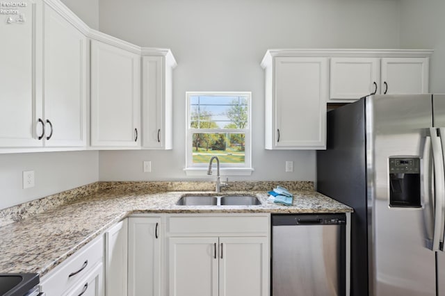 4340 E Mckenna Ln, Port Clinton, OH 43452 - kitchen with stainless steel appliances, a sink, white cabinetry, and light stone countertops