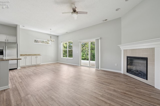 4340 E Mckenna Ln, Port Clinton, OH 43452 - unfurnished living room with ceiling fan, a chandelier, healthy amount of natural light, and light wood-type flooring