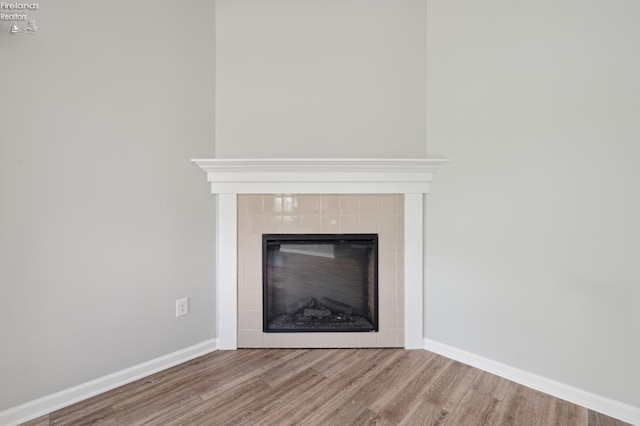 4340 E Mckenna Ln, Port Clinton, OH 43452 - detailed view of wood finished floors, baseboards, and a tile fireplace