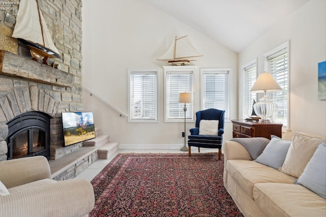 2951 N Chickadee Prt, Clinton, OH 43452 - living area featuring a stone fireplace, baseboards, tile patterned floors, and high vaulted ceiling