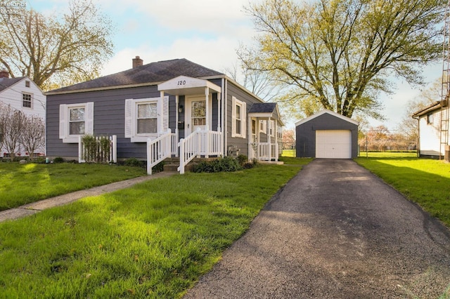120 Schiller Ave, Sandusky, OH 44870 - view of front of house with a front lawn, a detached garage, driveway, a chimney, and an outdoor structure
