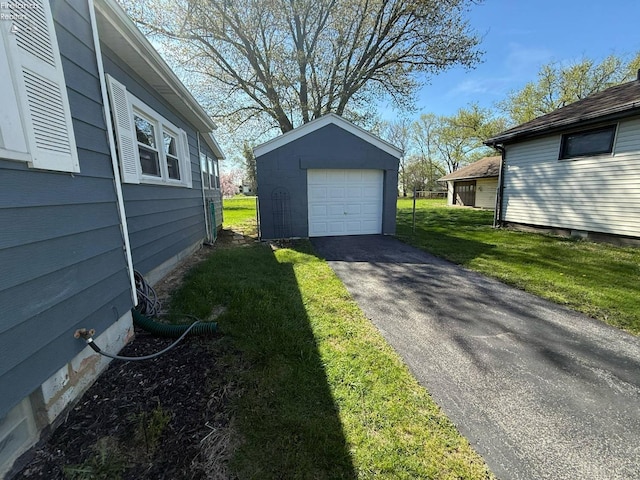 120 Schiller Ave, Sandusky, OH 44870 - exterior space featuring an outdoor structure, aphalt driveway, and a detached garage