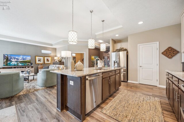 4220 Mckenna Ln, Port Clinton, OH 43452 - kitchen with light wood-style flooring, dark brown cabinets, stainless steel appliances, and a sink
