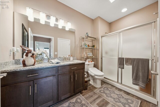 4220 Mckenna Ln, Port Clinton, OH 43452 - full bath with toilet, vanity, wood finished floors, and a stall shower