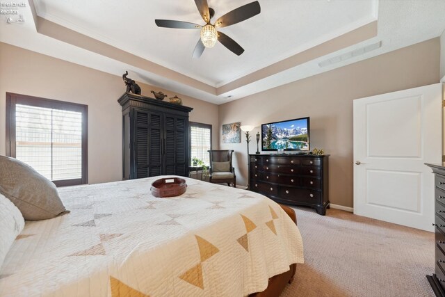 4220 Mckenna Ln, Port Clinton, OH 43452 - bedroom with visible vents, light carpet, a tray ceiling, and ornamental molding
