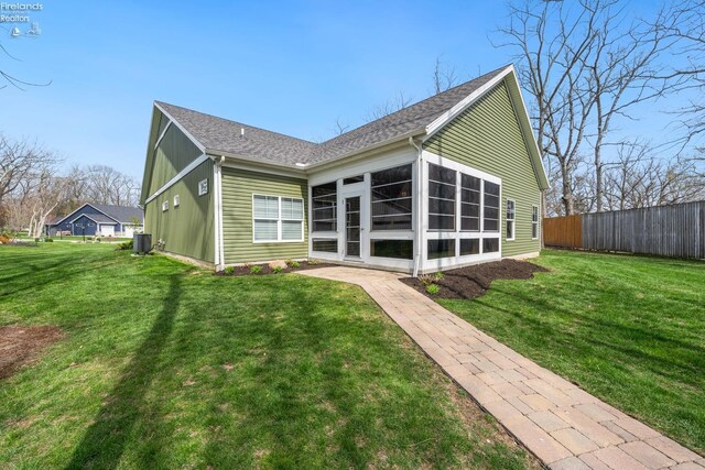 4220 Mckenna Ln, Port Clinton, OH 43452 - back of house featuring fence, roof with shingles, a yard, and central air condition unit