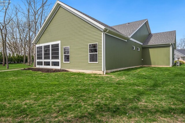 4220 Mckenna Ln, Port Clinton, OH 43452 - rear view of house with a lawn and roof with shingles