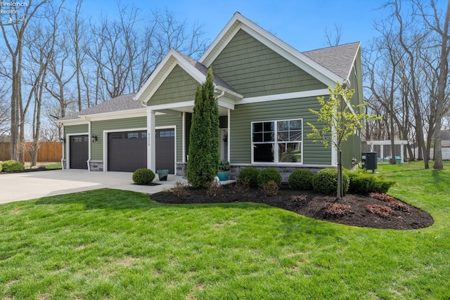 4220 Mckenna Ln, Port Clinton, OH 43452 - view of front facade with central AC, driveway, an attached garage, fence, and a front yard
