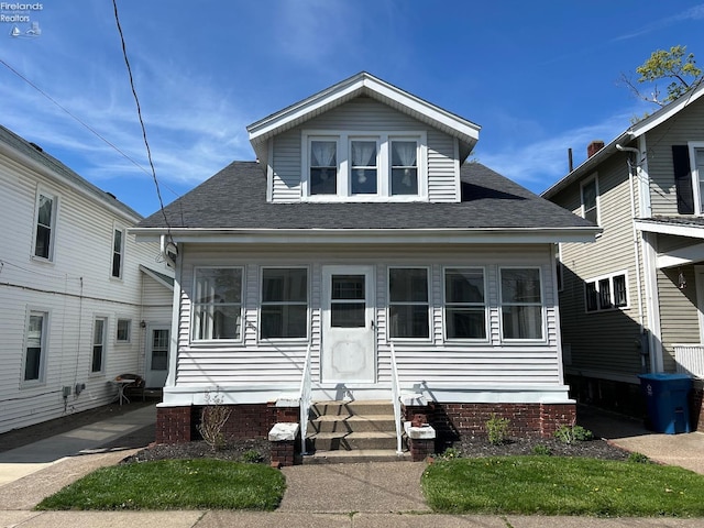 701 Polk St, Sandusky, OH 44870 - bungalow-style home with a shingled roof and entry steps