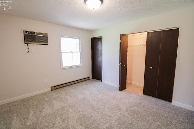 624 Shumaker Dr, Bellevue, OH 44811 - unfurnished bedroom featuring a baseboard heating unit, a closet, a wall mounted AC, and light colored carpet