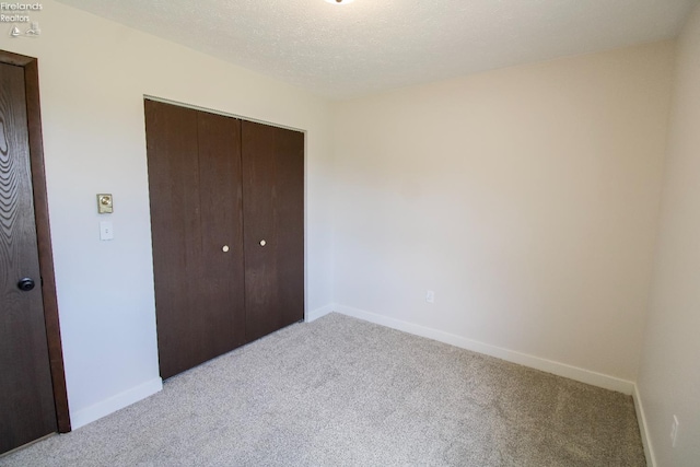 624 Shumaker Dr, Bellevue, OH 44811 - unfurnished bedroom featuring baseboards, light carpet, and a closet