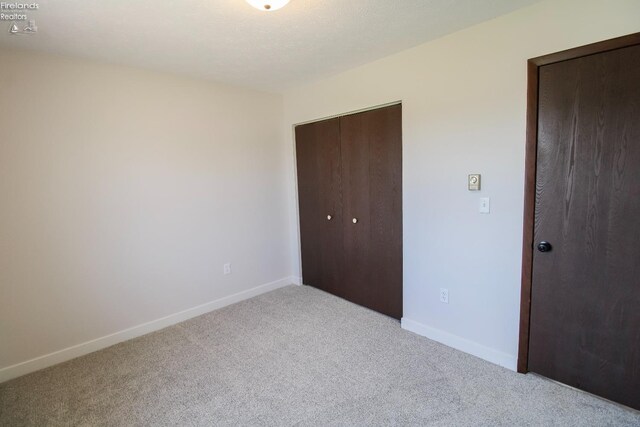 624 Shumaker Dr, Bellevue, OH 44811 - unfurnished bedroom with carpet flooring and baseboards