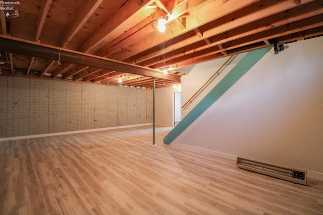 624 Shumaker Dr, Bellevue, OH 44811 - unfinished below grade area with baseboards, stairway, and wood finished floors