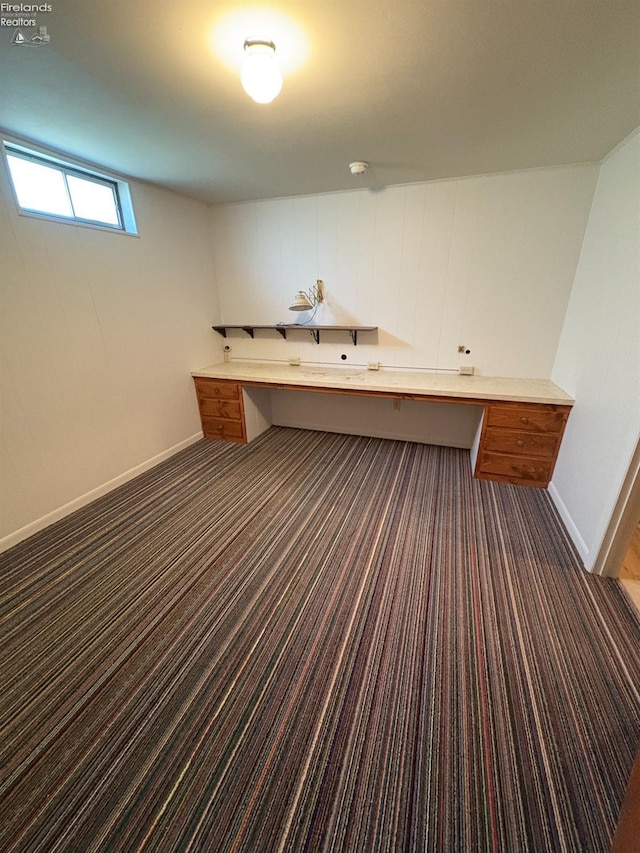 624 Shumaker Dr, Bellevue, OH 44811 - interior space featuring built in study area, carpet floors, and baseboards