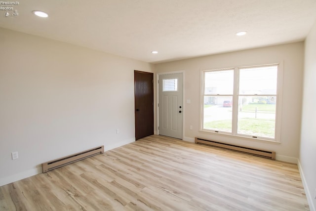 624 Shumaker Dr, Bellevue, OH 44811 - interior space featuring light wood-style floors, recessed lighting, and a baseboard heating unit