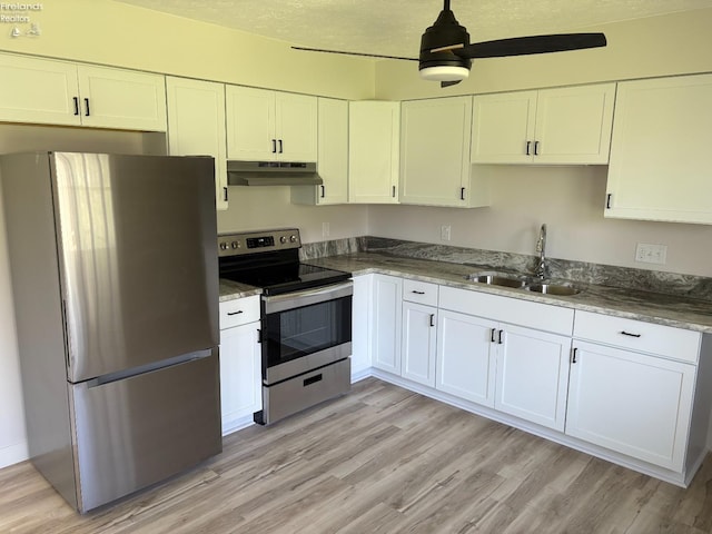 624 Shumaker Dr, Bellevue, OH 44811 - kitchen featuring a sink, under cabinet range hood, light wood-style floors, ceiling fan, and appliances with stainless steel finishes