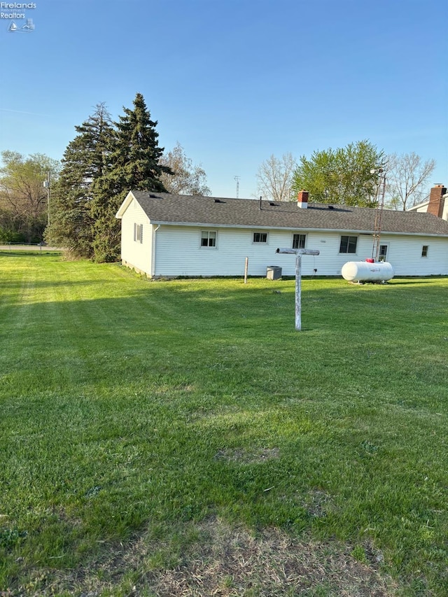 6814 Parker Rd, Castalia, OH 44824 - rear view of property featuring a yard and a chimney