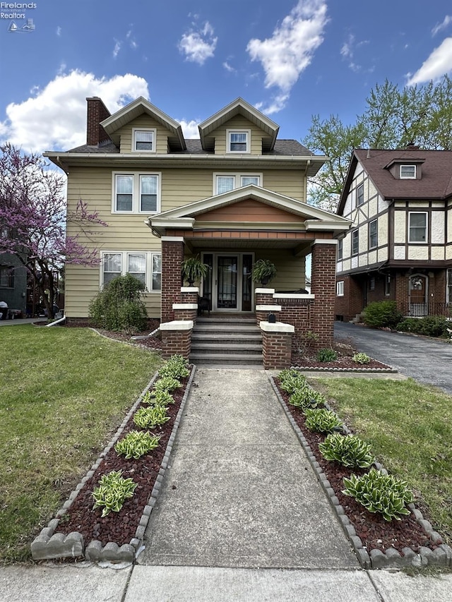 123 E Main, Norwalk, OH 44857 - view of front of house with a front yard, a chimney, a porch, and brick siding