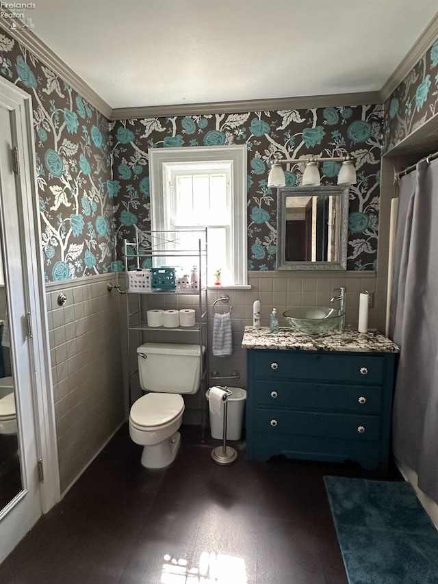 123 E Main, Norwalk, OH 44857 - bathroom featuring toilet, wallpapered walls, wainscoting, and ornamental molding