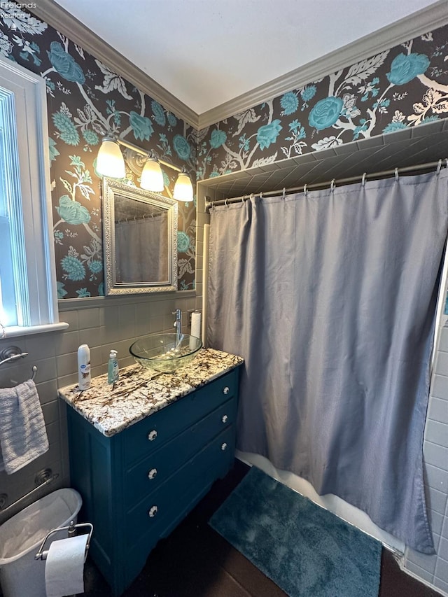 123 E Main, Norwalk, OH 44857 - bathroom with wallpapered walls, tile walls, a wainscoted wall, vanity, and crown molding
