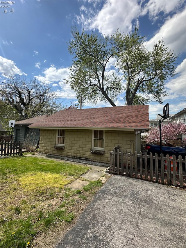 123 E Main, Norwalk, OH 44857 - rear view of house with a fenced front yard and roof with shingles