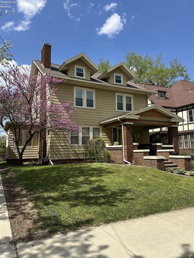123 E Main, Norwalk, OH 44857 - view of front of house featuring a chimney and a front yard