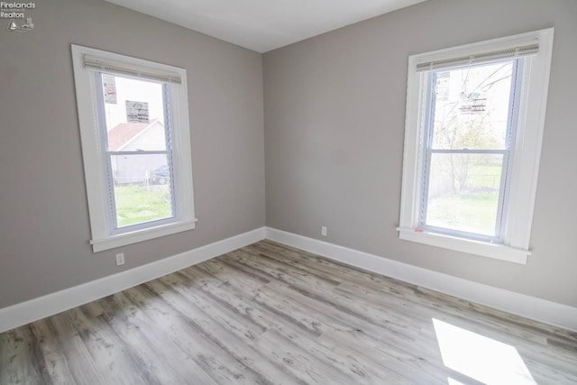 2615 Columbus Ave, Sandusky, OH 44870 - spare room featuring a wealth of natural light, wood finished floors, and baseboards