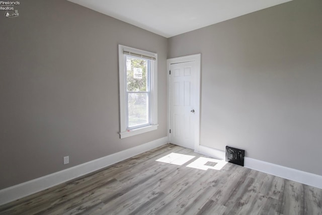 2615 Columbus Ave, Sandusky, OH 44870 - empty room with baseboards, visible vents, and wood finished floors