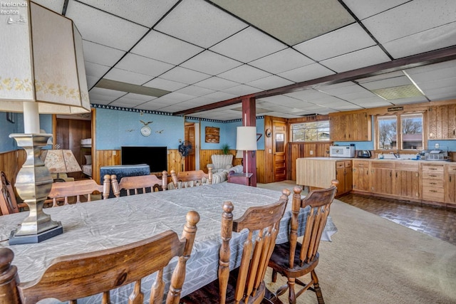 1270 Deist Rd, Middle Bass Island, OH 43446 - dining area featuring wooden walls, carpet flooring, and a drop ceiling