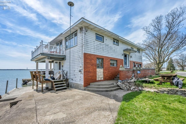 1270 Deist Rd, Middle Bass Island, OH 43446 - exterior space featuring brick siding, a water view, and a balcony