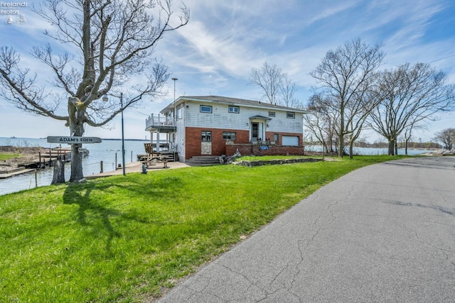 1270 Deist Rd, Middle Bass Island, OH 43446 - bi-level home featuring a front yard, a balcony, a water view, brick siding, and a dock