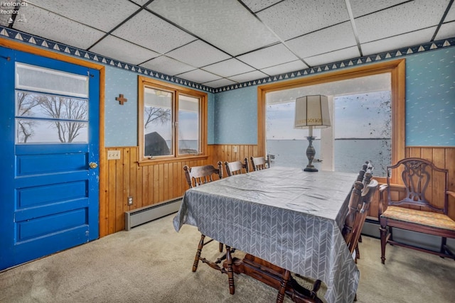1270 Deist Rd, Middle Bass Island, OH 43446 - carpeted dining area featuring wooden walls, a paneled ceiling, a wainscoted wall, and a baseboard heating unit