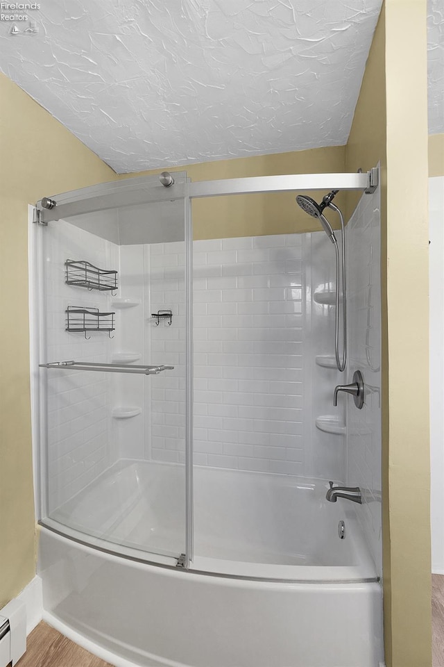 1507 S Lakeview Blvd, Lorain, OH 44052 - full bathroom with baseboards, wood finished floors, bath / shower combo with glass door, and a baseboard radiator