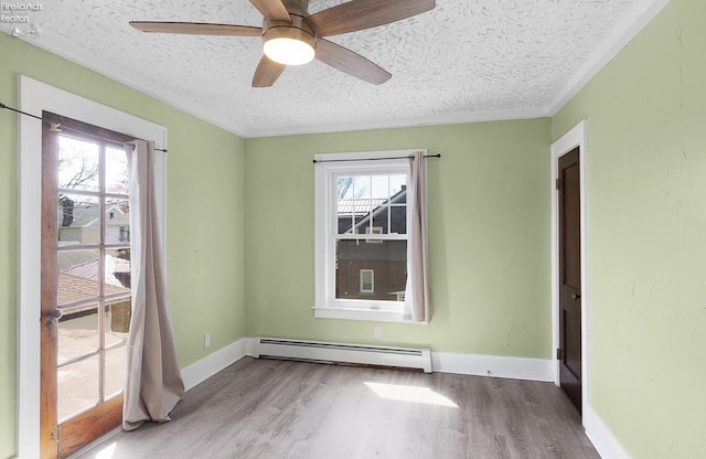 1507 S Lakeview Blvd, Lorain, OH 44052 - unfurnished room with ceiling fan, baseboards, a textured ceiling, wood finished floors, and a baseboard radiator
