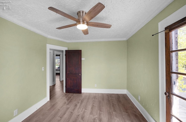 1507 S Lakeview Blvd, Lorain, OH 44052 - unfurnished room with a textured ceiling, ceiling fan, wood finished floors, and baseboards